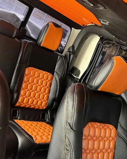 Custom orange and black diamond-stitched van seats